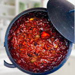 A hearty bowl of slow-simmered FLORIBBEAN FIREHOUSE CHILI featuring hand-chopped beef, dark rum, and warm island spices by Chef Winston.