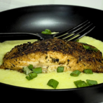 Cast Iron Jerk Salmon & Creamy Grits by Chef Winston served with creamy stone-ground grits and perfectly seared salmon