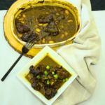 Braised Oxtail with Butter Beans by Chef Winston served with rich gravy and Caribbean-inspired sides