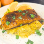 Floribbean Orange and Rum Glazed Salmon with Sweet Plantain Mash by Chef Winston served with tropical citrus glaze and fresh herbs