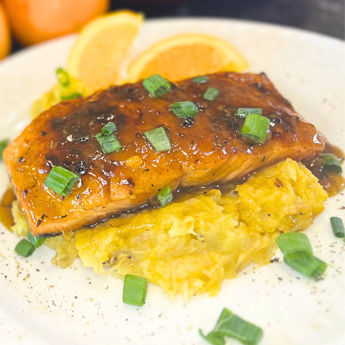 Floribbean Orange and Rum Glazed Salmon with Sweet Plantain Mash by Chef Winston served with tropical citrus glaze and fresh herbs