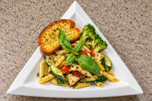 Floribbean Chicken Primavera with penne pasta, chicken and colorful vegetables by Chef Winston
